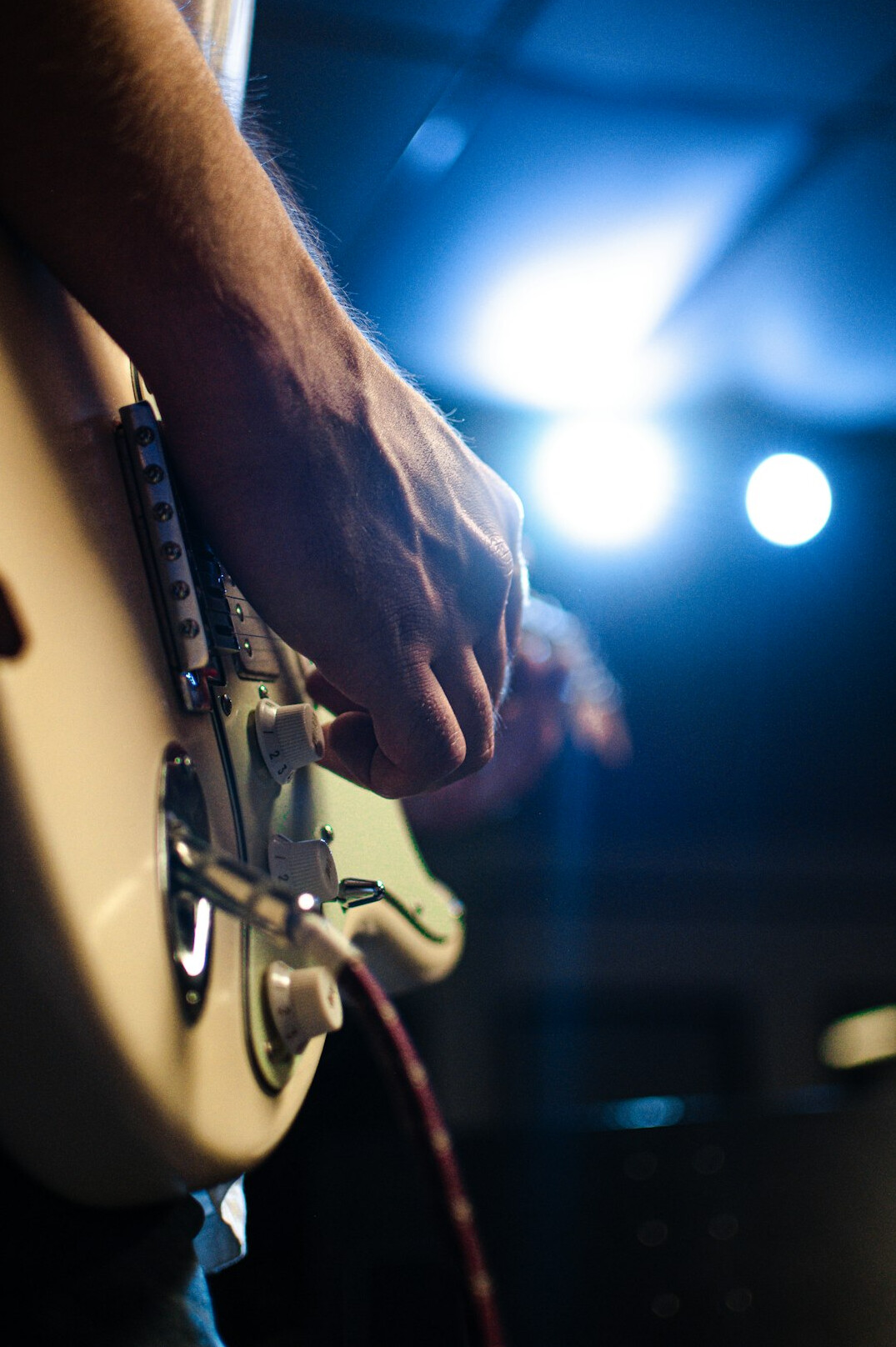 musician playing guitar stage
